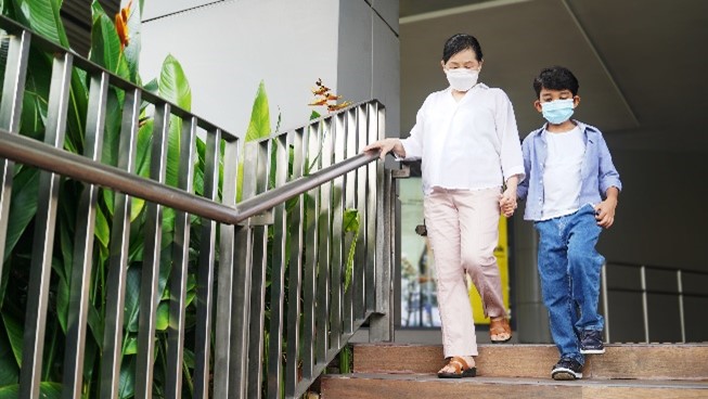 Grandmother and grandchild walking doen steps together