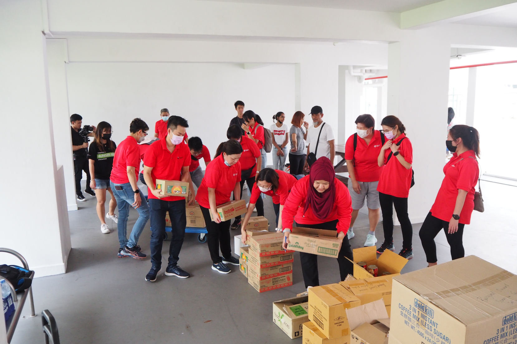 Frasers Property employees in Singapore packing food bundles.