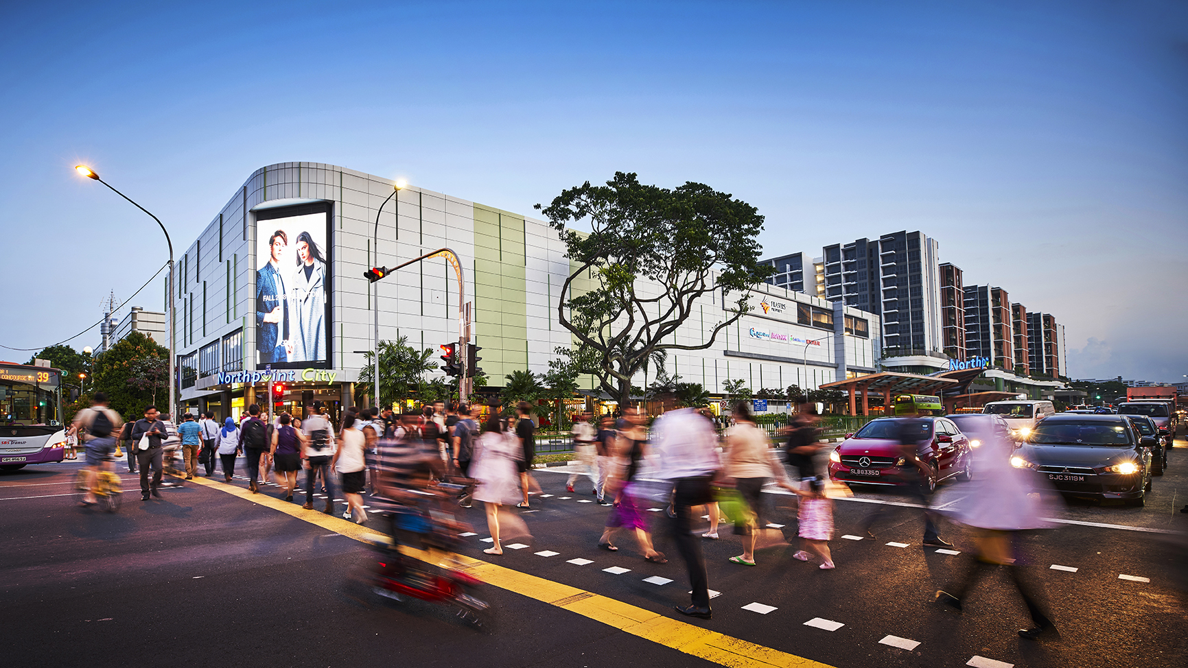 Bustling scene of people crossing the road to Northpoint City in Yishun, Singapore