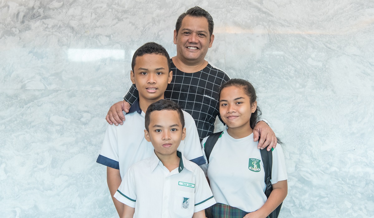 Jufri and his children pose for cameras before the ceremony.