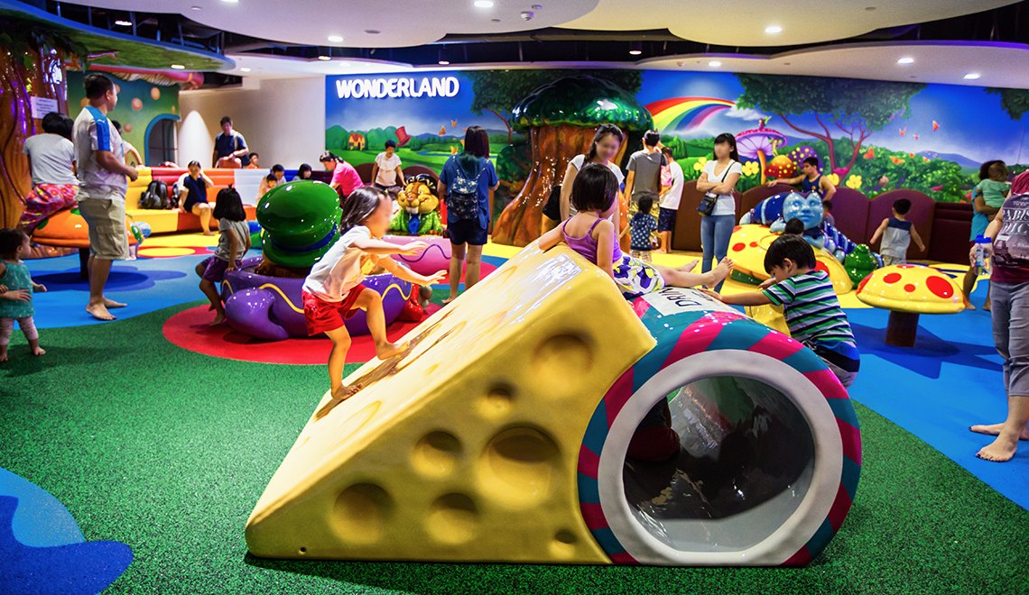 Children climbing up an over-sized cheese at Wonderland, Level 2, Waterway Point.