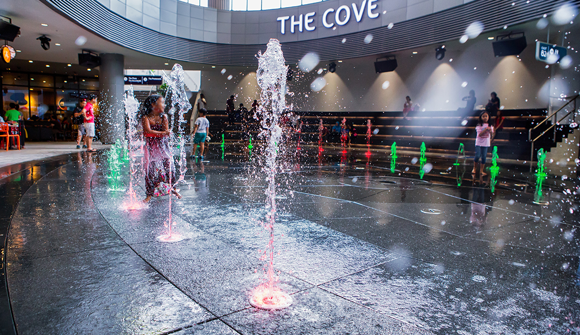 Children can experience running through rain-simulating water shooters at The Cove, Basement 2 Waterway Point.