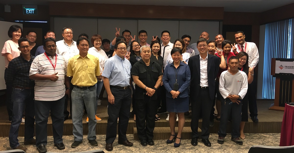 A group photo of Robert and his fellow colleagues at the farewell party.
