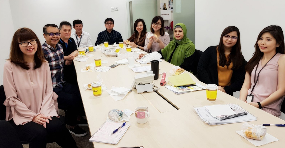 A meeting without snacks and drinks are unlike Jeffrey (centre) and his team