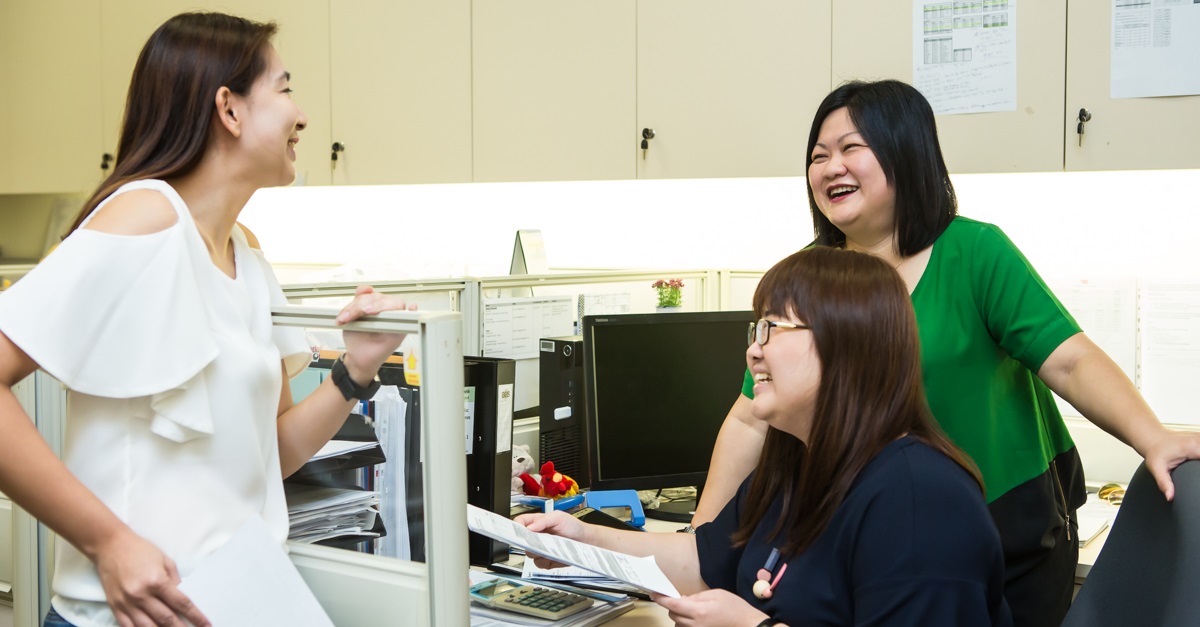 Donna sharing a light-hearted moment with two team members.