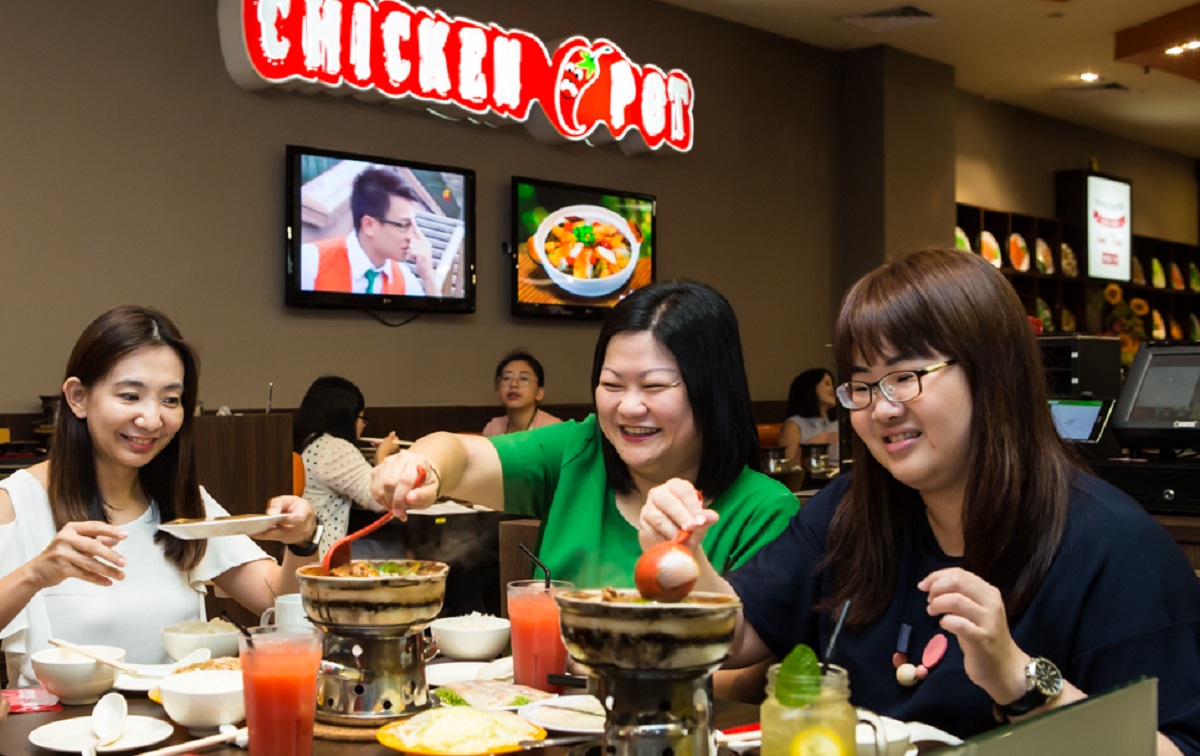 A team that eats together stays together; Donna with two of her team members tucking into a meal at Bedok Point.