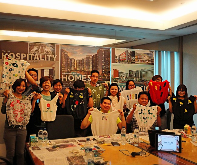 Eco workshop participants posing with their new, upcycled tote bags at Alexandra Point.