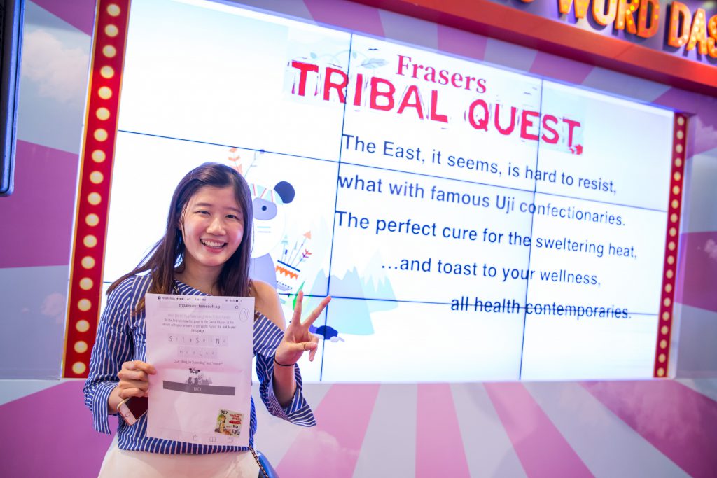 Ng Hui Hui, winner of the $5,000 Frasers Centrepoint Malls Gift Card, posing with her answer to the word puzzle.