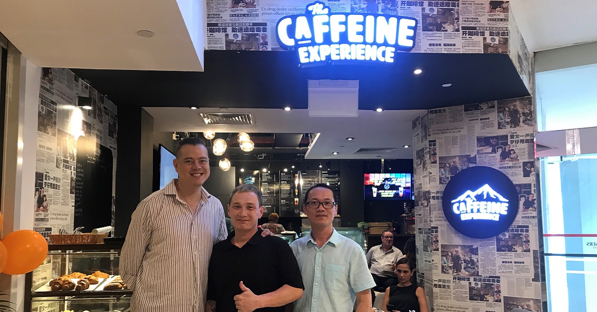 Matthew (left) and Hilary (right) with Bruce, their ambassador, at their newest The Caffeine Experience outlet.