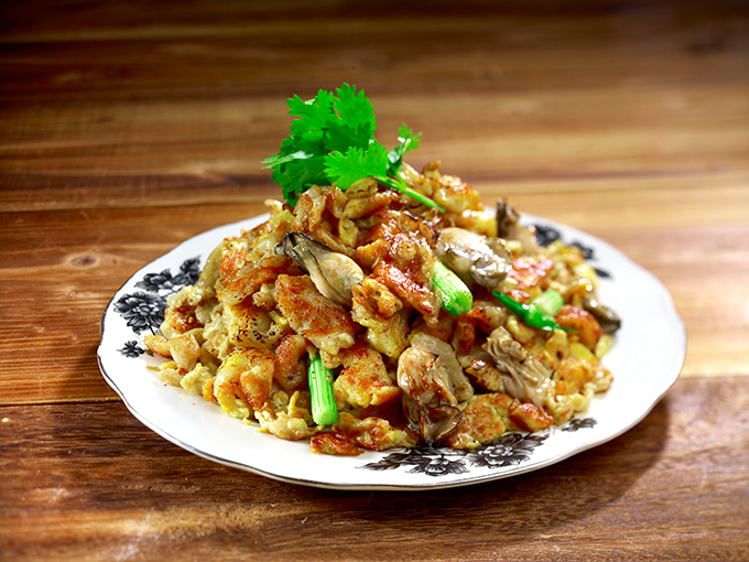 ‘Oyster Omelette’ at Malaysia Chiak is a delightful mix of rice flour batter, eggs and oysters fried on high heat on a flat griddle served with a bowl of dip made of chilli sauce and garlic.