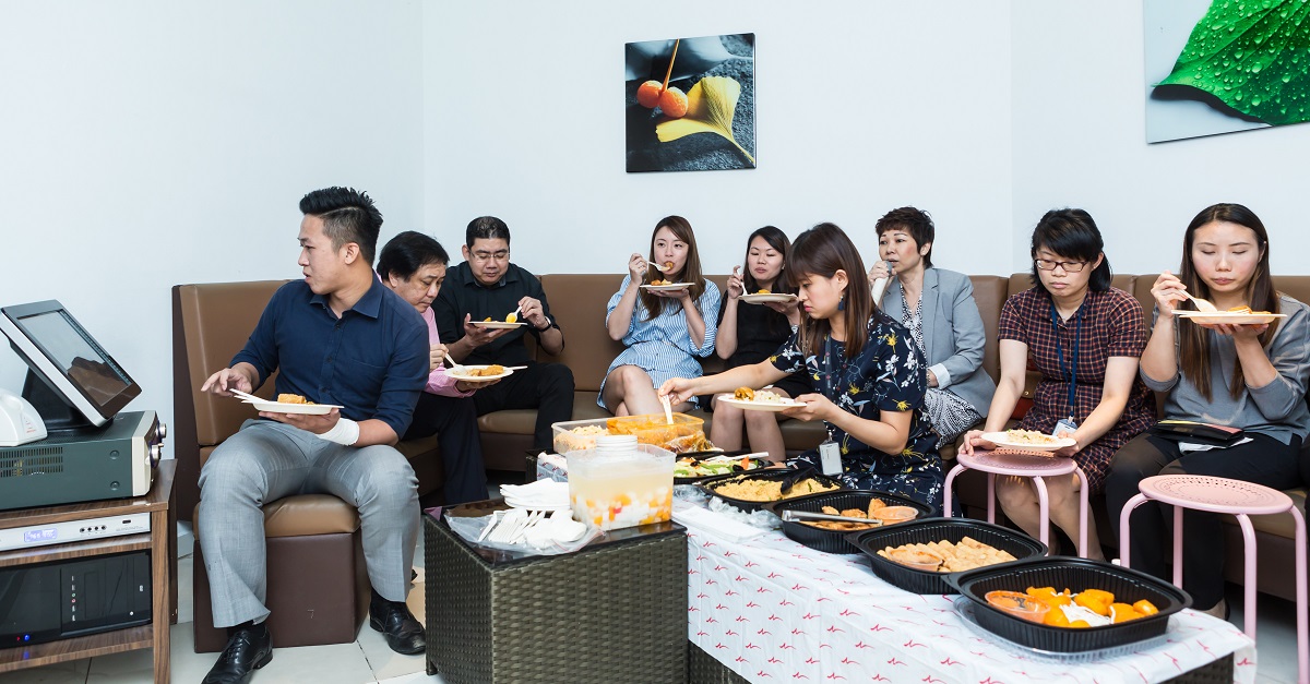 Elsie (seated, third from right) having a time-out with her team in a lunch-cum-karaoke session.