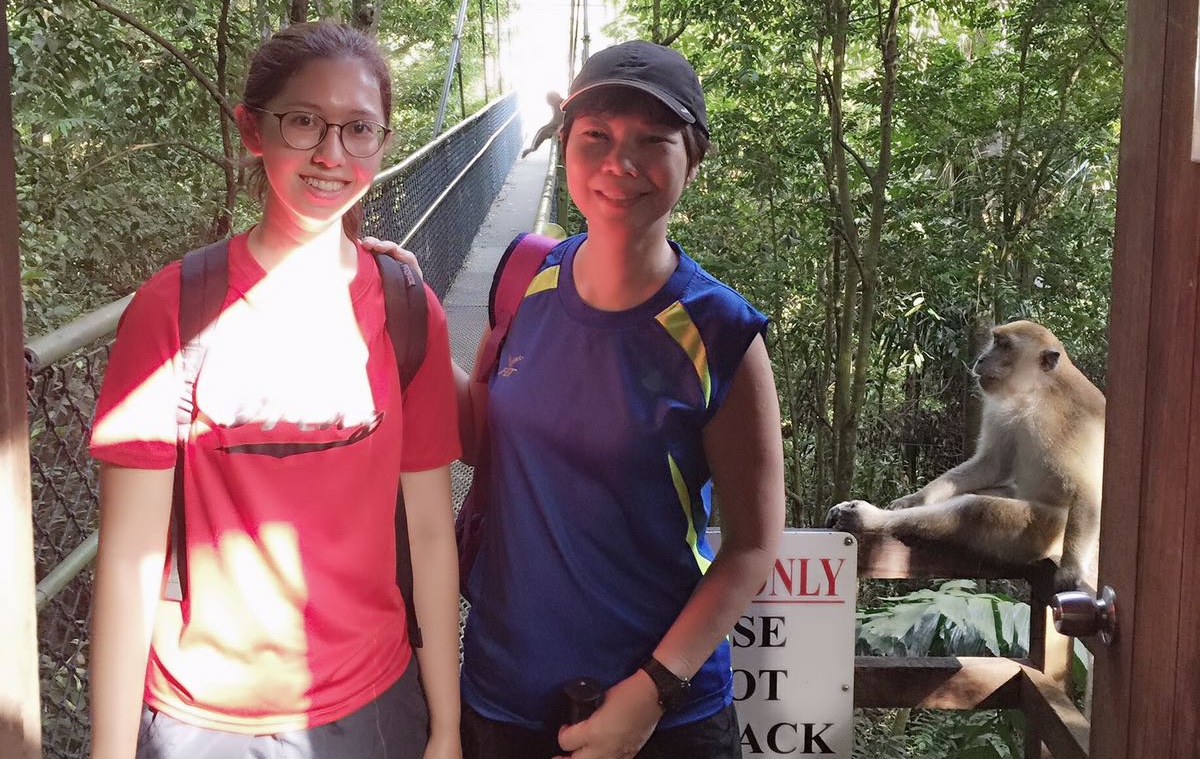 Elsie (right), on a trekking adventure with one of her daughters, and a mischievous monkey looking on and pondering its next move.