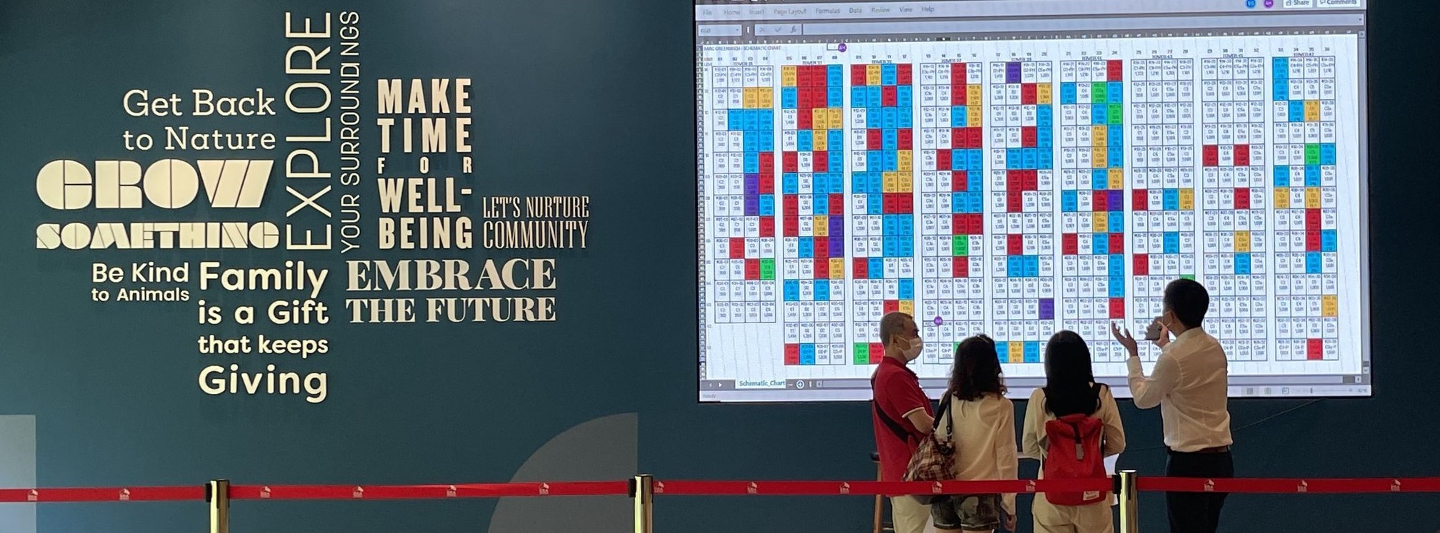 Potential homebuyers looking at the sales chart at Parc Greenwich showsuite